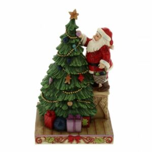 Un albero di Sorbo con decorazioni natalizie circondato da una famiglia unita un maschio adulto, una donna, una sposa, una femmina e un bambino Una scena di felicità che rappresenta il festival di Natale che viene trasmesso dai genitori ai loro figli